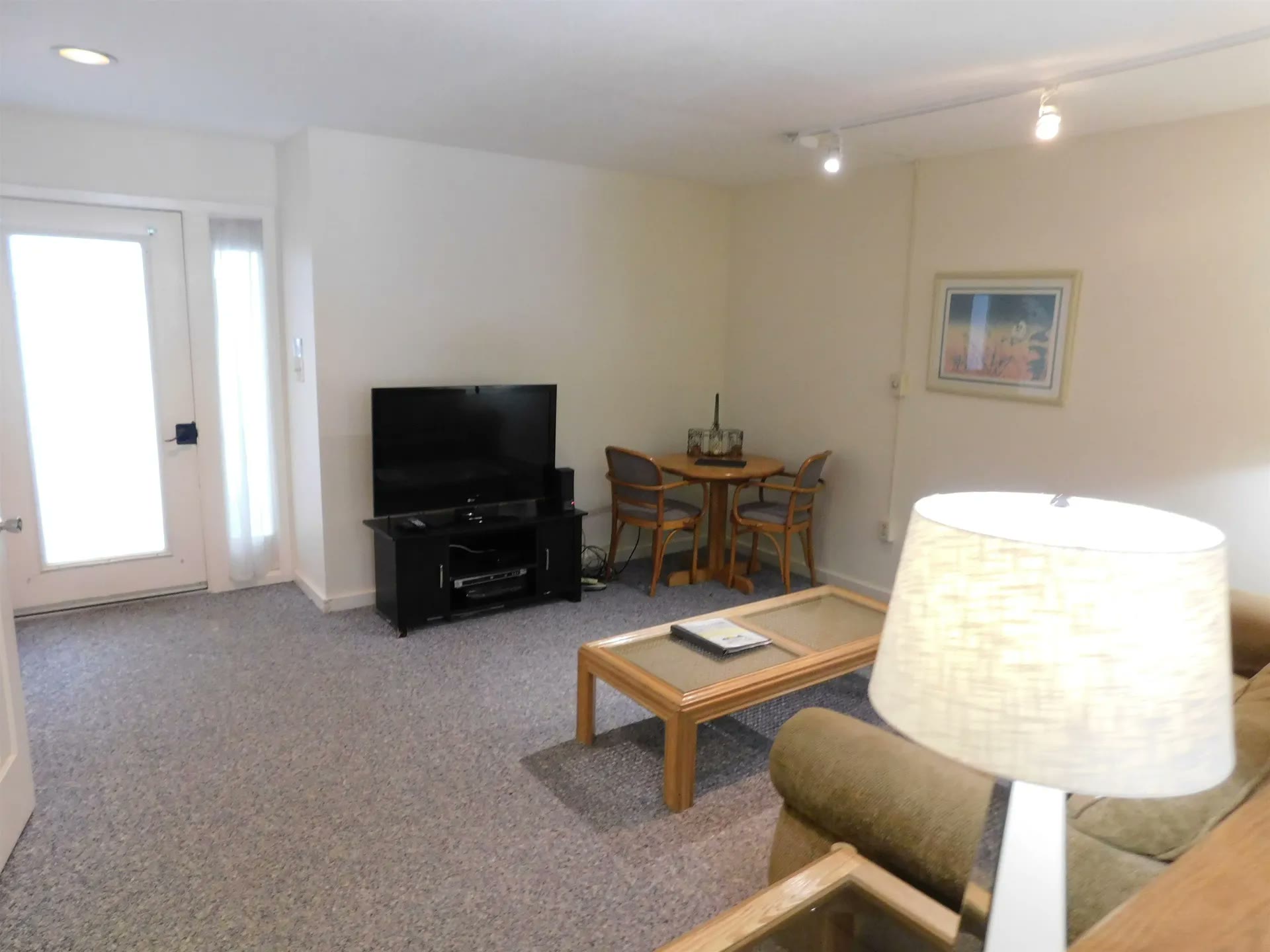 Den with a TV and a small game table