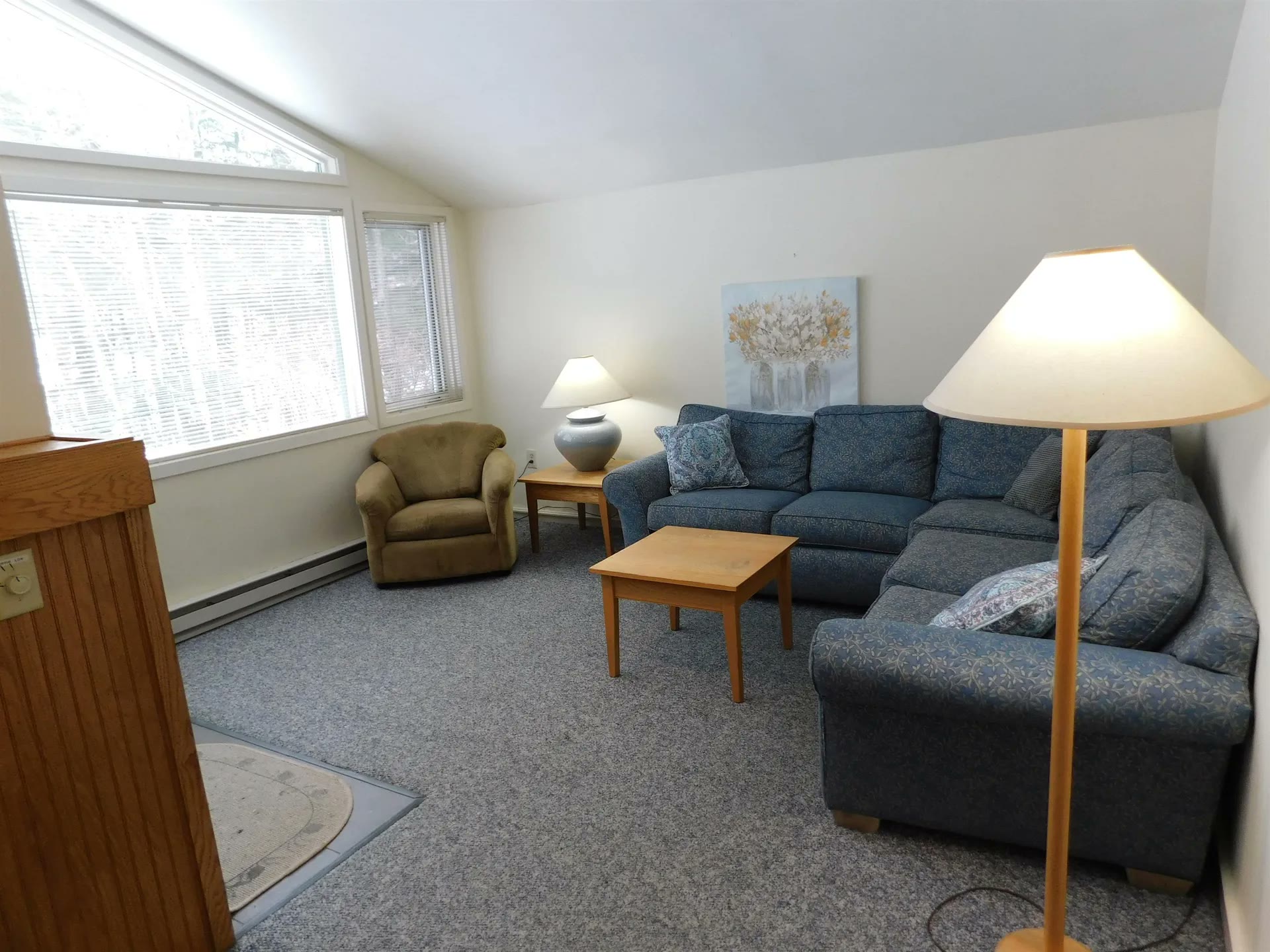 Bright upper-level living room with a sectional sofa