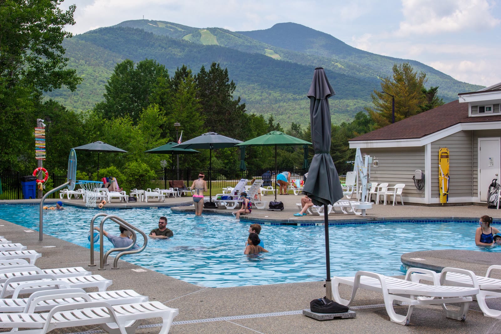Outdoor pool at the White Mountain Athletic Club with Mount Tecumseh behind it