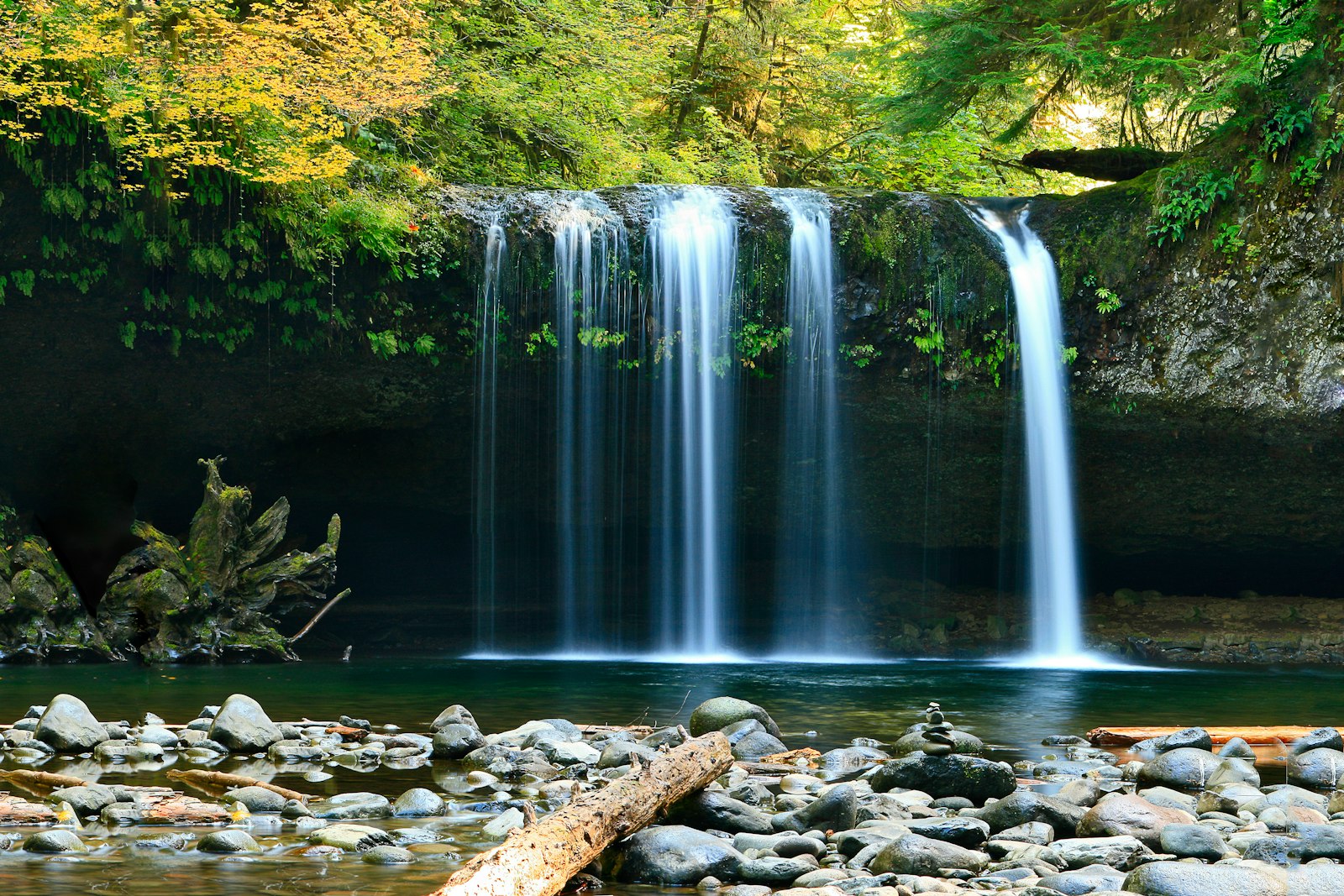 Clear mountain water spilling into a rocky pool